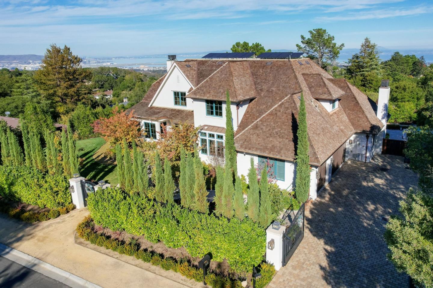 This gorgeous home is situated on a gated over half-acre lot with breathtaking bay views. Built-in 2015 using the finest materials and with great attention to detail, this home has all the modern amenities you desire. Amenities include an office/den, formal living room with fireplace, formal dining room, butler's pantry, a great room comprised of the chef's kitchen, breakfast area, and family room, a mudroom, a powder room, a laundry room, and 5 en-suite bedrooms with tray ceilings. Among the kitchen appliances are a full-sized Sub-ZeroÂ® wine refrigerator,  a WolfÂ® 6-burner range with matching exhaust hood, WolfÂ® built-in convection oven and built-in microwave, Sub-ZeroÂ® refrigerator and freezer, and two dishwashers. The family has a high coved ceiling and a fireplace. Throughout the home, you will find recessed lighting, striking light fixtures, crown molding, and hardwood, marble, and travertine flooring. Outside, you will find sprawling lawns, a large patio, and a heated pool.