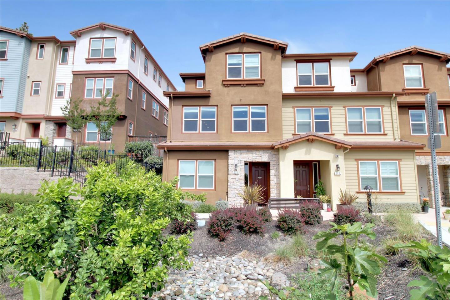 Absolutely gorgeous executive townhouse. One of the best location of the complex as an end-unit overlooking city and mountain views. This is 1 out of a few units in the entire complex that is zoned C2 to have business and residential mix. Ideal front unit with direct street access to ADA approved bedroom/work space, multi functional floor plan on ground floor w full bath. Middle floor has direct access to 2 car attached finished garage with family room, dining area, open airy gleaming gourmet kitchen for entertaining. Stunning marble island, stainless appliances and tile backsplash are a dream for the gourmet chef. Spacious maste-en-suite w deep walk-in closet, his/her marble vanity, luxurious shower/tub, washer and dryer upstairs for convenience. Recessed lighting throughout, upgraded carpet, epoxy garage with extra cabinets for storage, perfect location walk to shops and restaurants. Room for everyone including having a business at home!
